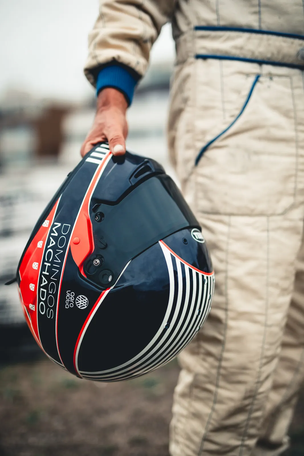 Domingos carrying his helmet, name on the side